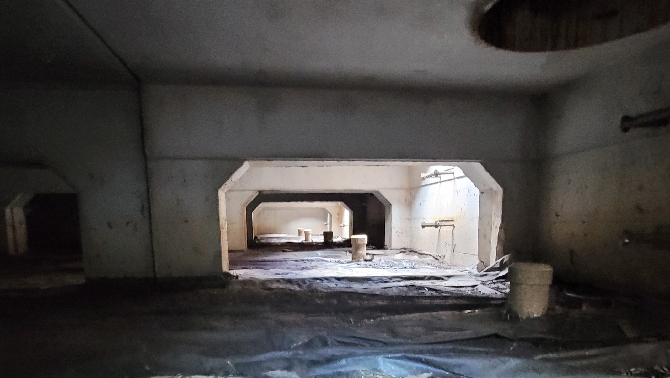 Technician inspecting an underground stormwater control measure (SCM) vault for sediment, debris, and structural integrity.