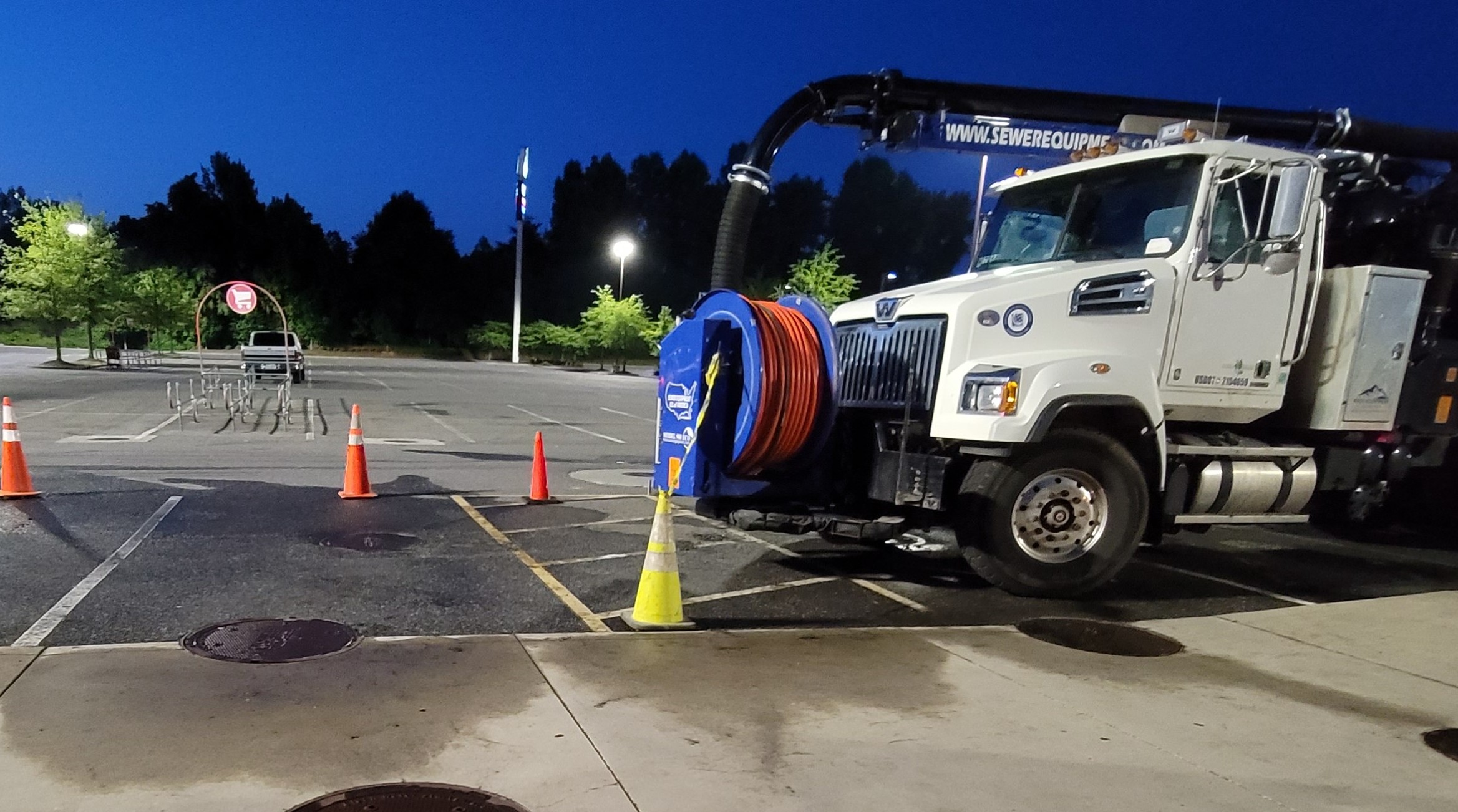 High-pressure jetter truck cleaning stormwater pipe system to remove sediment and debris buildup